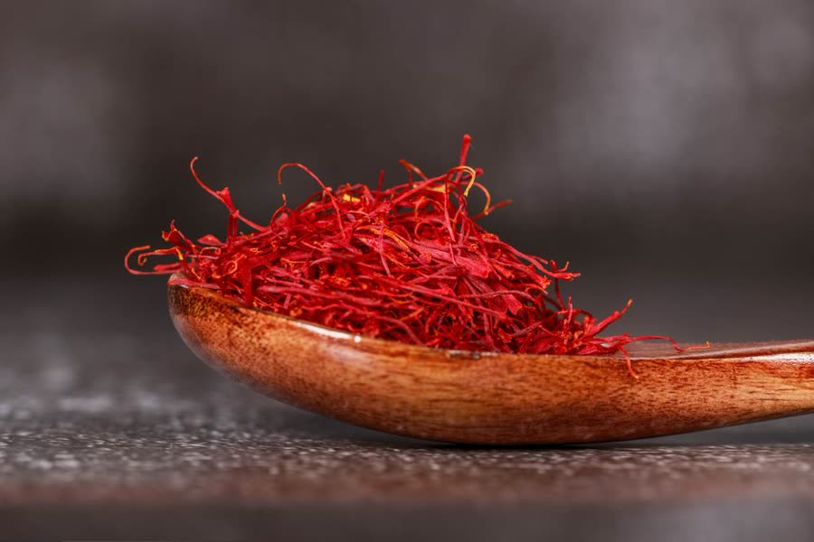 Persian saffron threads on a wooden spoon